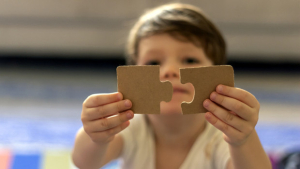 Puzzles in the hands of a child.